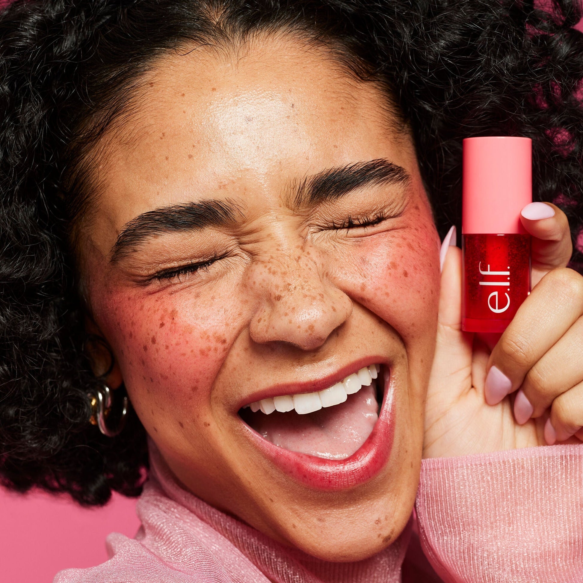 Person holding up Sheer For It on lips and cheeks  close-up  